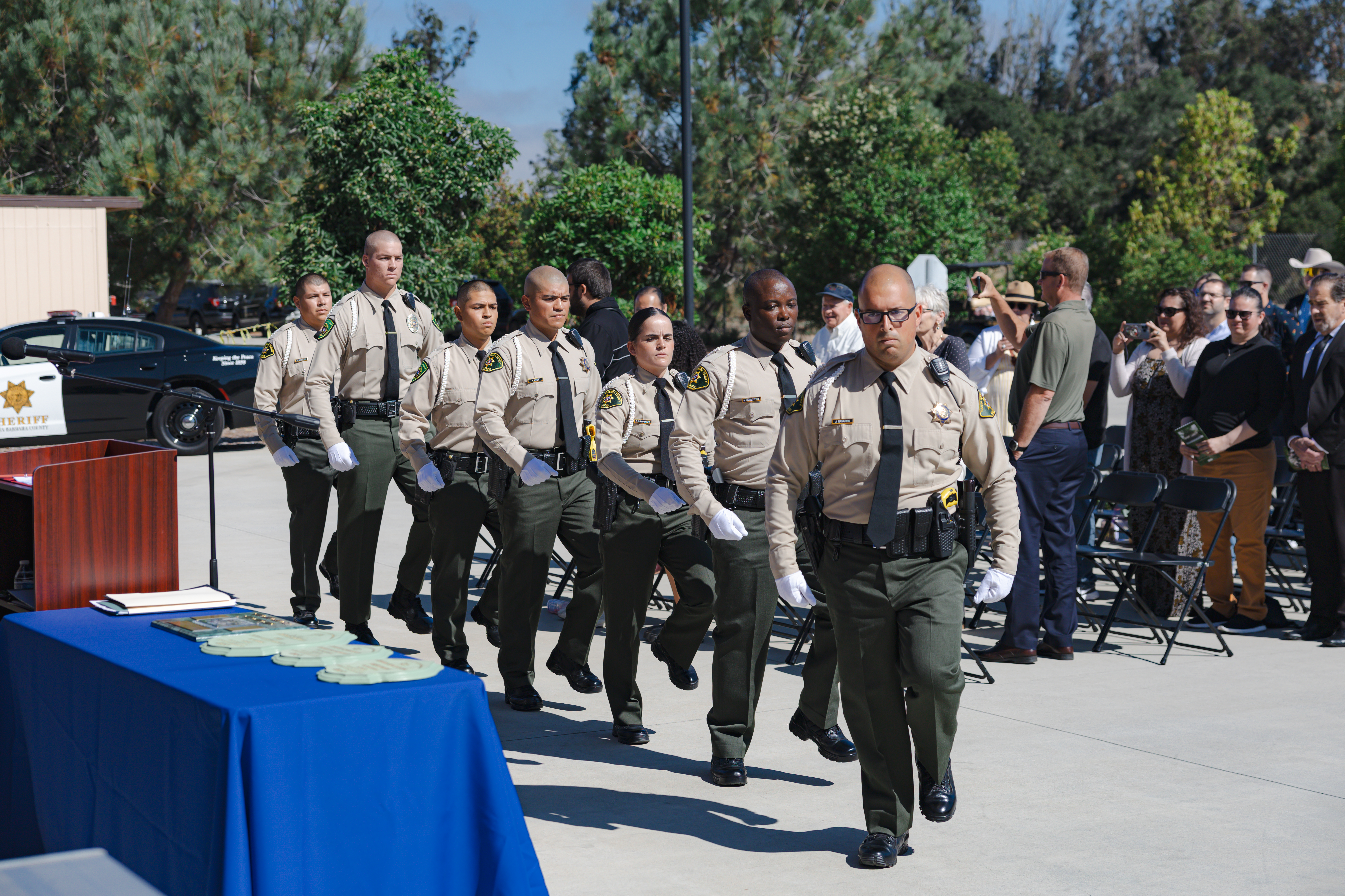Seven AHC Core Custody Academy Cadets marching. 